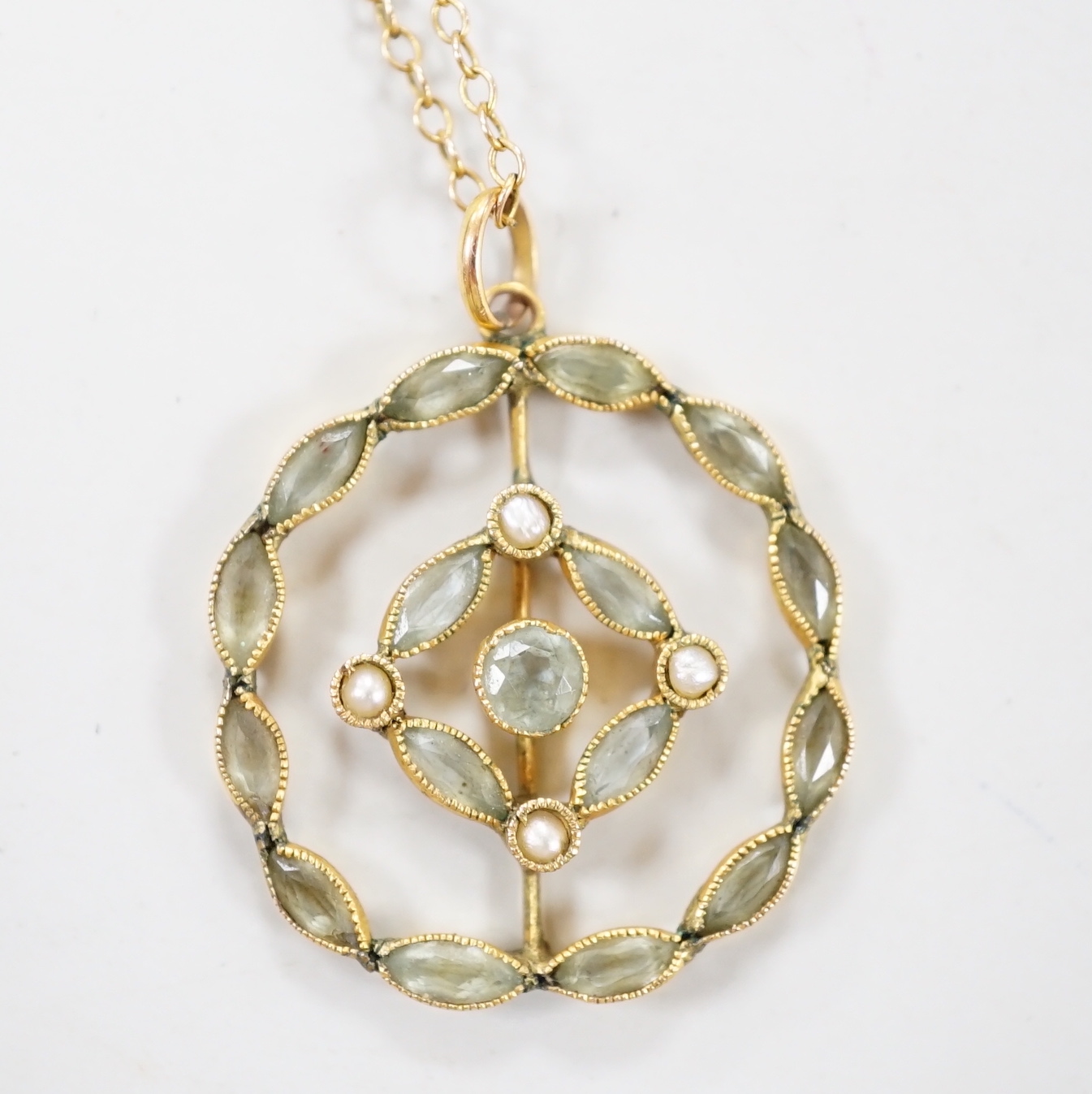 An Edwardian 9ct, aquamarine? and seed pearl set circular cluster pendant necklace, overall 48cm, gross 3.2 grams.